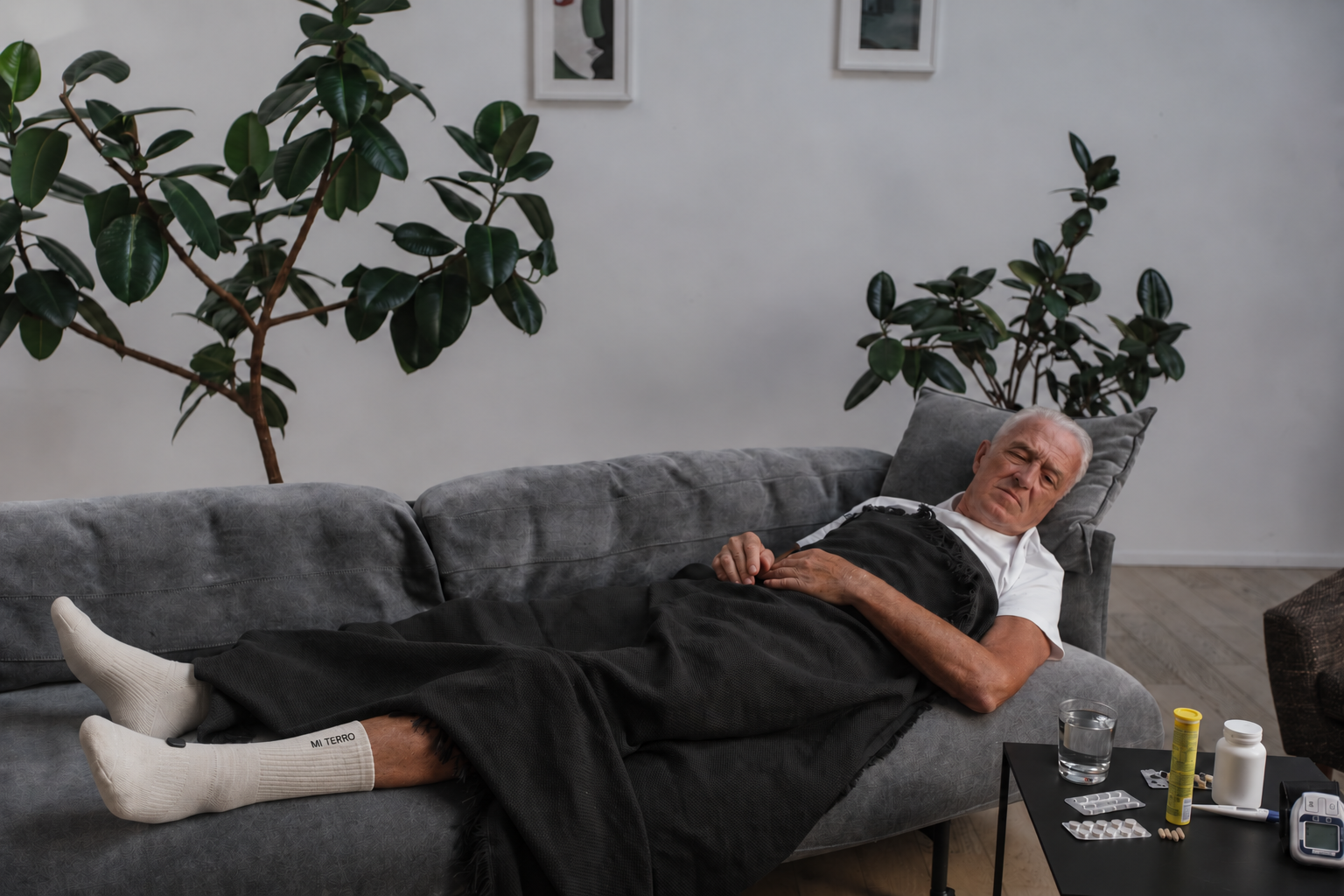 Older man resting on a sofa in cream Mi Terro sock visualization with an enclosed ankle module